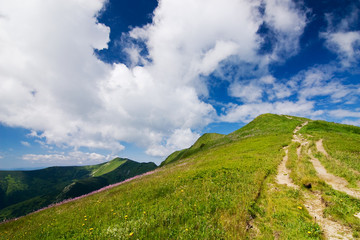 Mountain-ridge and blue sky with white clouds