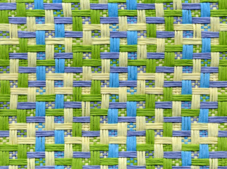 Close up view of webbing in green, blue, beige and violet tones