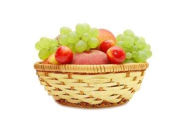 Fresh fruit in a wattled basket on a white background