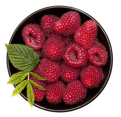 raspberries with leaves  in black bowl on white background
