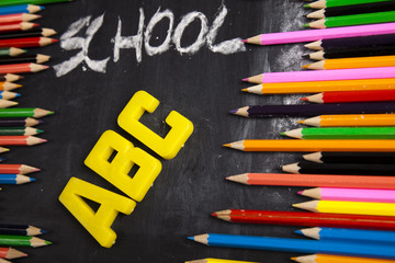 Colour pencils, alphabet and school