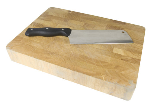 meat cleaver laying on wooden chopping board isolated on white