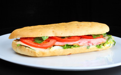 Delicious sandwich with tomatoes and chicken breast