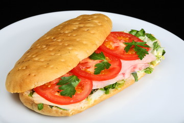 Delicious sandwich with tomatoes and chicken breast