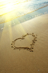 Heart drawn on sand, seacoast