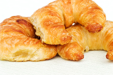 Three croissants on a light background