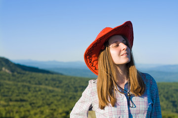 Young woman in cowboy looking hat