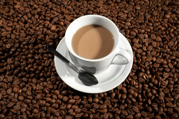 Fototapeta premium Cup with coffee, costing on coffee grain