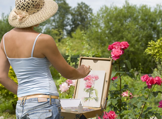 Young woman painting roses in the garden - Powered by Adobe