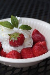 strawberries with cream, decorated with mint leaves