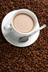 Cup with coffee, costing on coffee grain