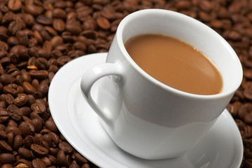 Cup with coffee, costing on coffee grain