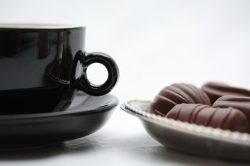 Espresso cup and luxury chocolates