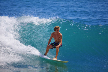 young man surfing at Point Panic, Hawaii
