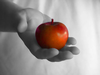 Hand holding a juicy healthy red apple