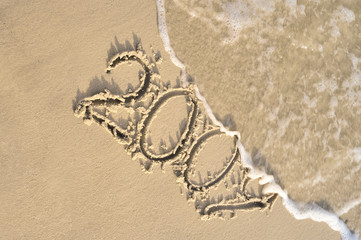 Inscription "2009" on sand