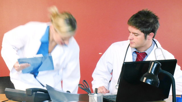 Young doctors working together in office footage