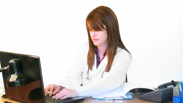 Brunette young doctor working in hospital office footage