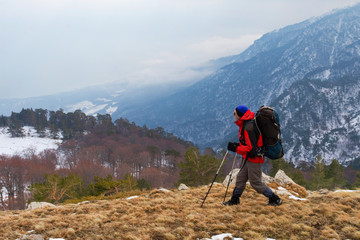 Hiker in winter in mountains