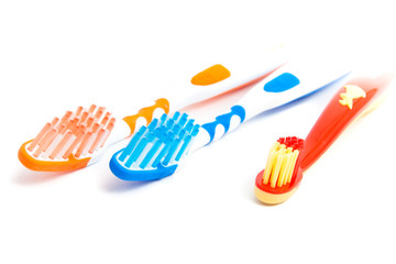 Family toothbrushes isolated on white
