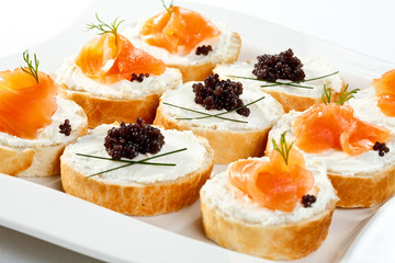 Mini sandwiches - bagel with cream cheese, salmon, caviar
