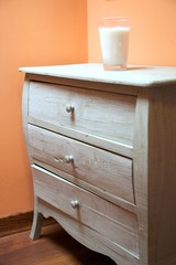 chest of drawers with candle glass