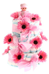 Pink three-tier diaper birthday cake isolated on white