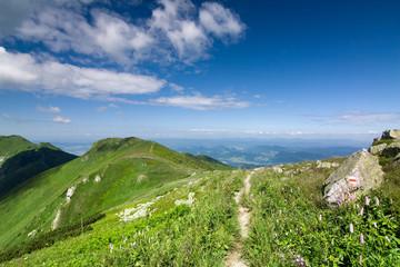 Mountain-ridge and blue sky with white clouds