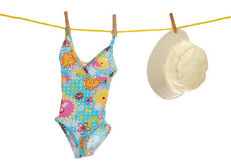 child's bathing suit and beach hat on clothes line