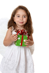 Little angel girl holding a christmas or other  gift