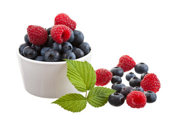 Raspberries and blueberries isolated on white background