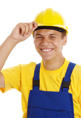 Young worker taking off his hard hat and smile