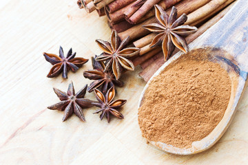 Ground cinnamon, anise stars and cinnamon sticks