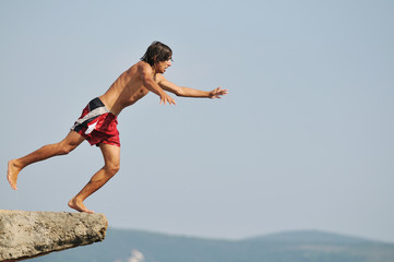 boy jump sea