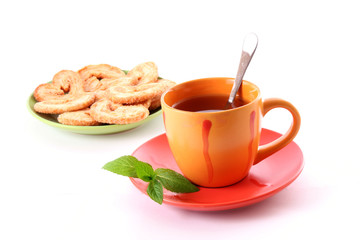Cup of green tea on the saucer with mint