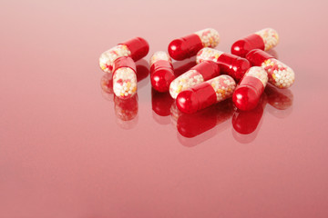 Doctor's stuff. Pills spilled on a glass surface