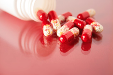 Doctor's stuff. Pills spilled on a glass surface