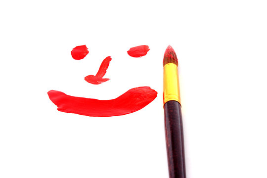 brush paints smile on paper