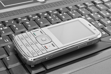 mobile phone lies on the laptop keyboard