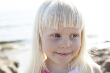 Smiling little girl outdoors.