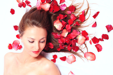 girl in petals of red roses