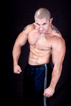 A perfect muscular man posing artistic