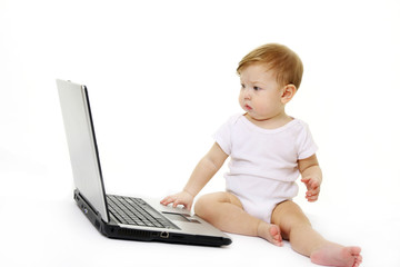 Small baby with laptop isolated on white
