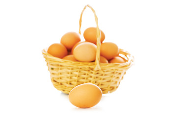 Basket full of eggs isolated on white
