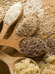 Wooden spoons with different kinds of groats. Shallow DOF.
