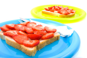 bread with strawberry on colorful plates