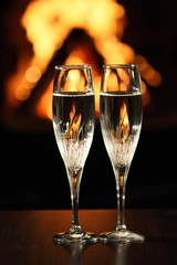 two glasses in front of fireplace