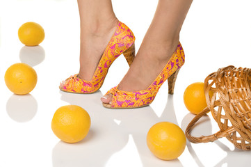 Woman feet with french pedicure and oranges