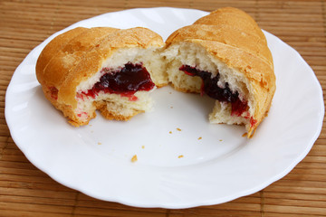 close-up croissant broken half-and-half on a plate