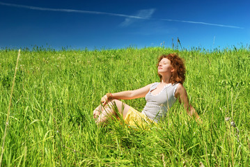 Young girl sitting on grass